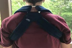 A person with back pain wearing a bracing on his back.