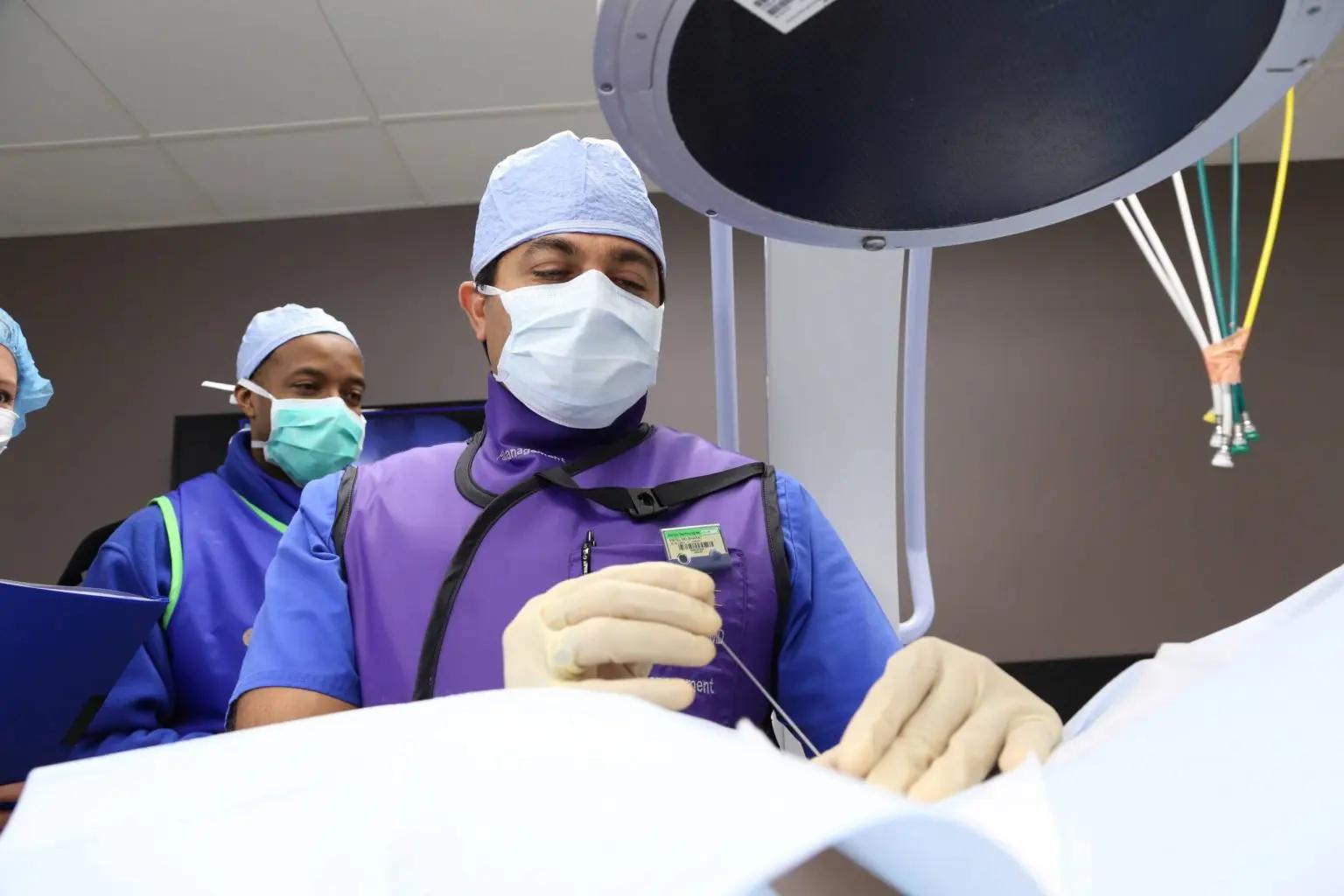 Surgeon with his team performing surgery in an operating room.