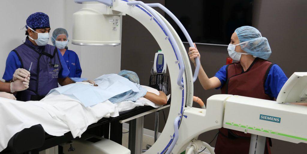 Medical team performing a procedure using advanced imaging technology.