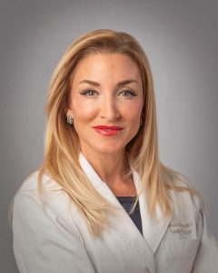 Dr. Stephanie Haridopolos Smiling in Lab Coat