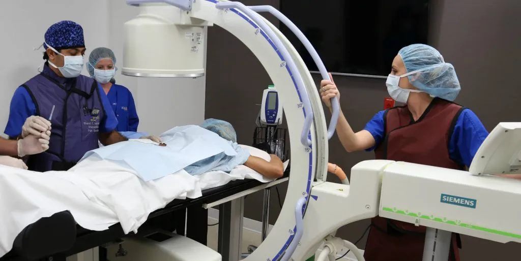 Medical team performing a procedure using advanced imaging technology.