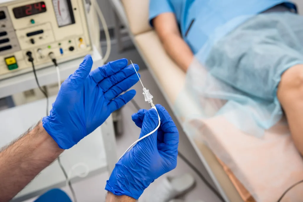 A medical professional in gloves holds a syringe near a patient, related to herniated disc treatment.