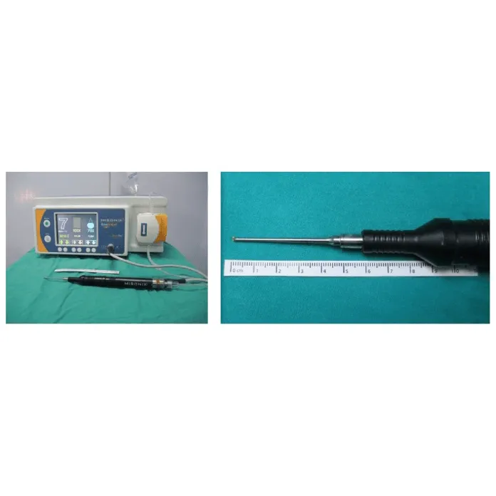 Medical device with control unit and probe next to a ruler on a green surface.