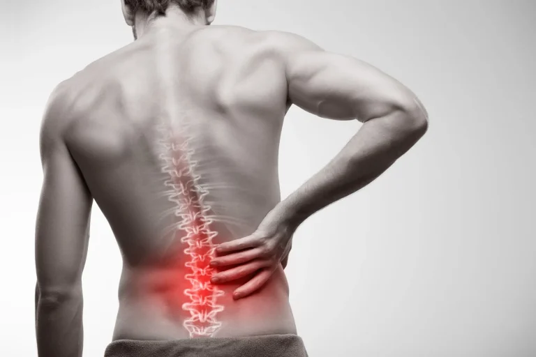 Man holding lower back with highlighted spine in pain.