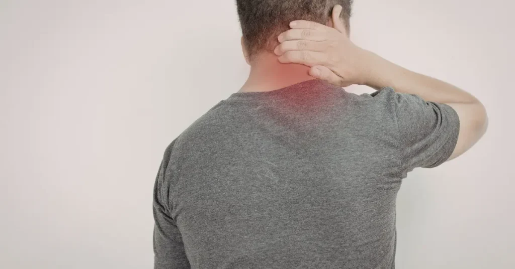 Man holding the back of his neck with highlighted pain area, representing a C5-C6 herniated disc.