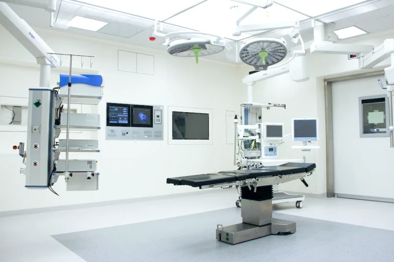 Modern hospital operating room with advanced medical equipment and monitors.