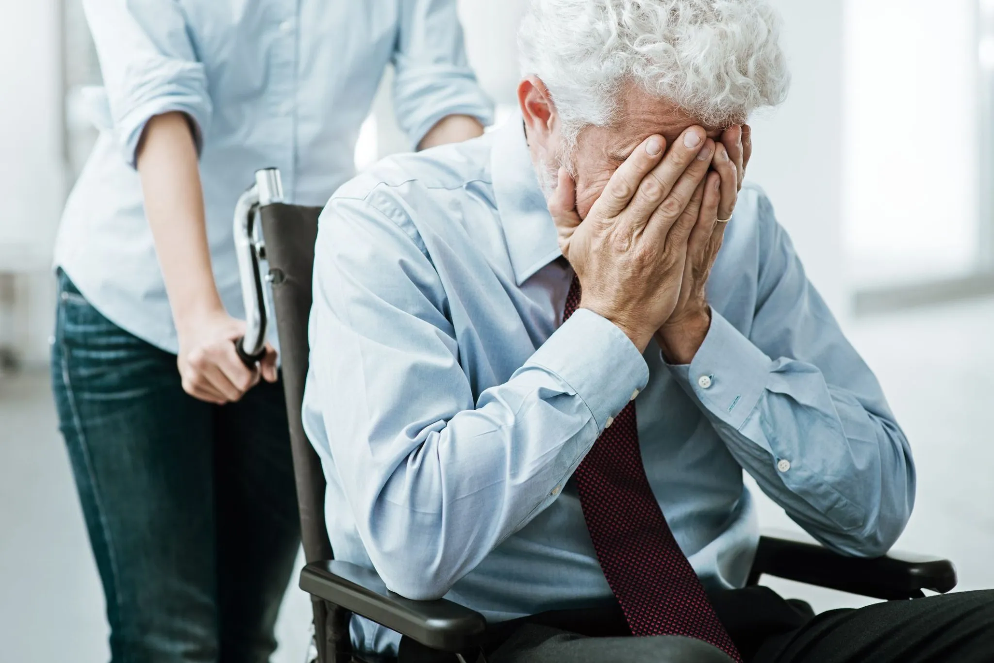a very upset man in wheelchair leaving hospital for rehab center 