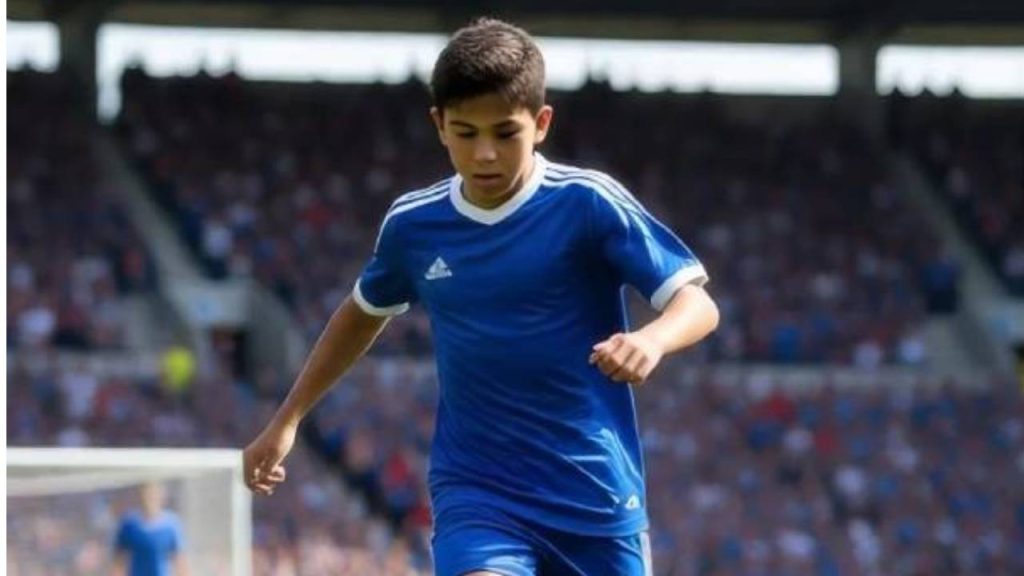 A young soccer player in a blue uniform runs on a field during a match.