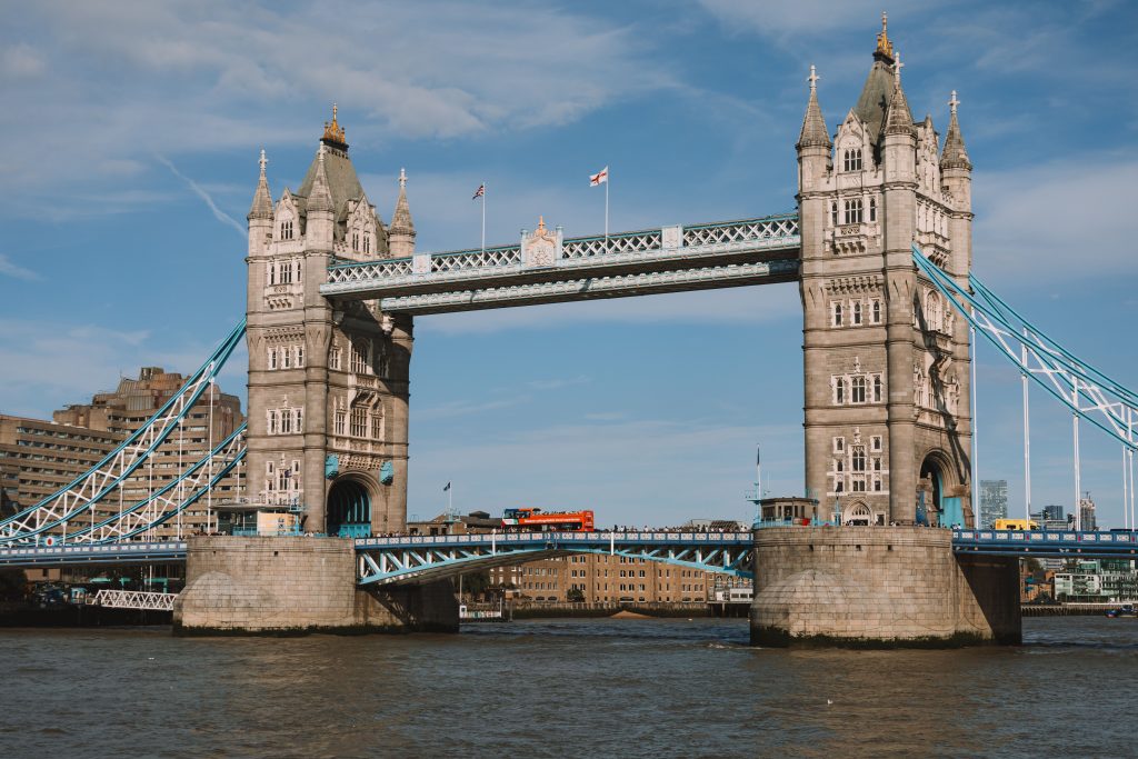 Tower Bridge over the River Thames with a red bus crossing.