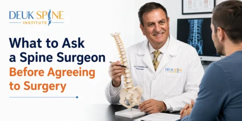 Dr. Deuk consulting with a patient while explaining a spine model, illustrating important questions to ask a spine surgeon before agreeing to spinal surgery.
