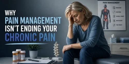 Woman holding her head, sitting in a doctor's office with a "pain management" sign.