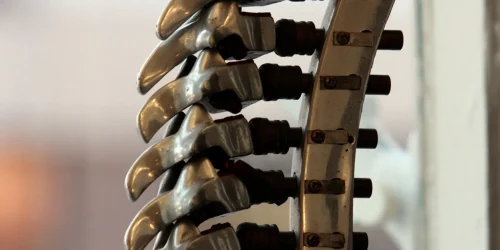 Close-up of a metal spinal model, illustrating spinal fusion surgery risks and complications.