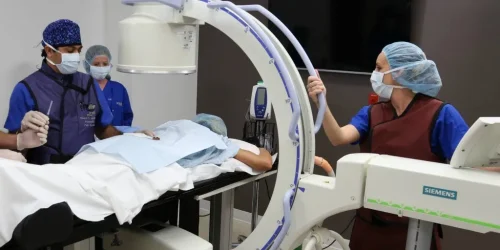 Medical team performing a procedure using advanced imaging technology.