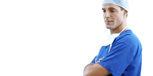 ale surgeon in blue scrubs and cap standing with arms crossed.