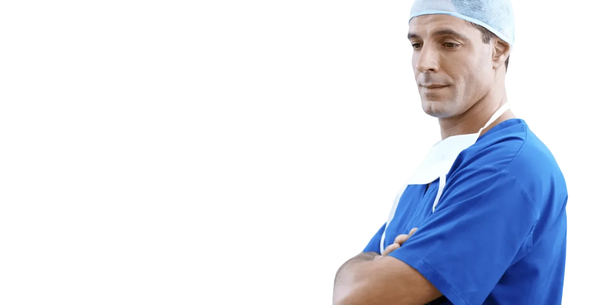 ale surgeon in blue scrubs and cap standing with arms crossed.